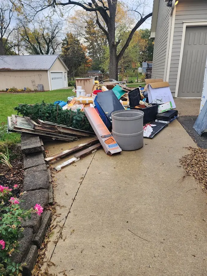 Dumpster being loaded with debris for Estate Cleanout Dumpster Rental in Leawood